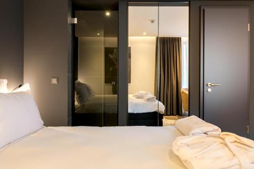a hotel room with a bed and a mirror at Sellmann´s Boutique Hotel in Dortmund
