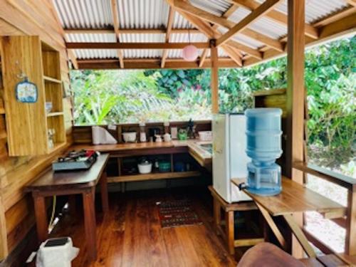 a large kitchen with a table and a refrigerator at Casonita in Manzanillo