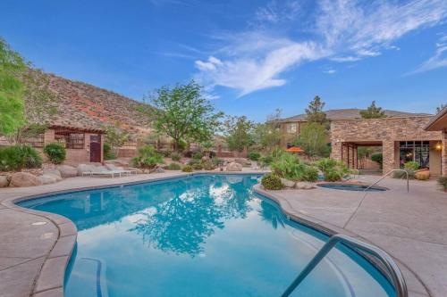 a swimming pool in a yard with a house at Coral Springs A8 3 Bedrooms BBQ Grill, Cable TV, 2 Private Fireplaces, Soaker Bathtub Resort Pool in Hurricane