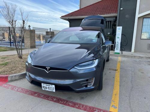 a black car parked in a parking lot at La Quinta by Wyndham Alvarado in Alvarado