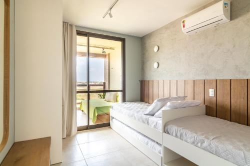 Cet appartement comprend une chambre avec deux lits et un balcon. dans l'établissement Apartamento Lindo e Completo - Wai Wai Cumbuco, à Cumbuco