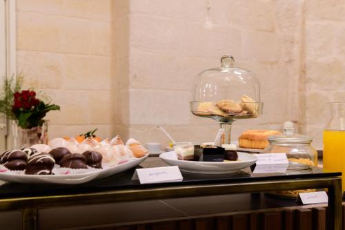 a buffet of pastries and desserts on a table at Le Malve Cave Retreat in Matera
