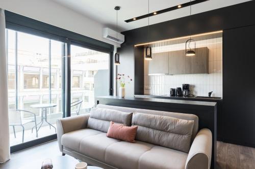 a living room with a couch and a kitchen at Voda Luxury Residence #501 in Athens