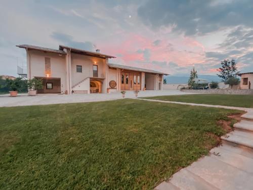 a house with a lawn in front of it at Amaranto Bed & Breakfast in Cavour