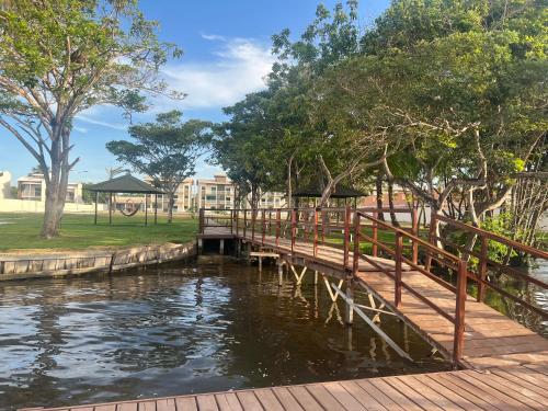 a wooden bridge over a body of water at Apartamento nos Lencois Confort in Barreirinhas
