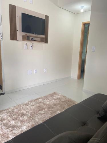 a living room with a flat screen tv on the wall at Apartamento nos Lencois Confort in Barreirinhas