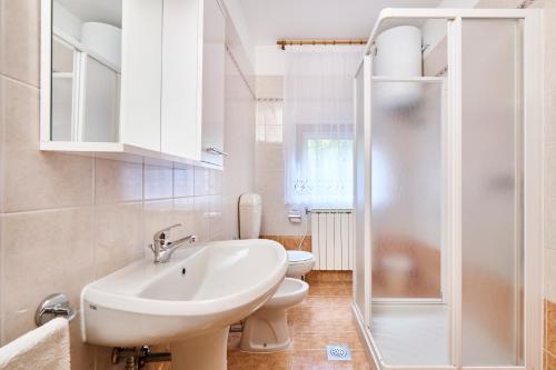 W łazience znajduje się umywalka, toaleta i prysznic. w obiekcie Anna Apartments w mieście Zambratija