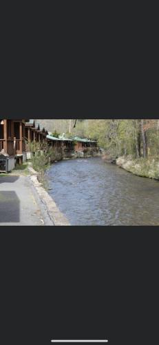 a view of a river with a bridge in the distance at Qualla Cabins and Motel Cherokee near Casino in Whittier