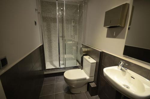 a bathroom with a toilet and a sink and a shower at Free Hostels Barcelona in Barcelona