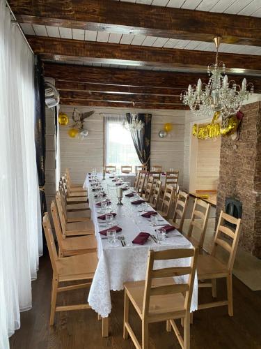 a long dining room with a long table and chairs at Homestead - Ukmergė area 