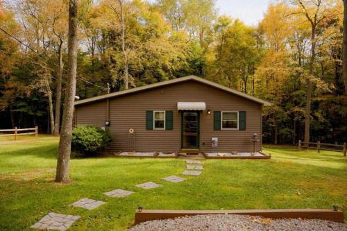 a small house in the middle of a yard at Maple Creek Cabin, minutes from Cook Forest, ANF in Marienville