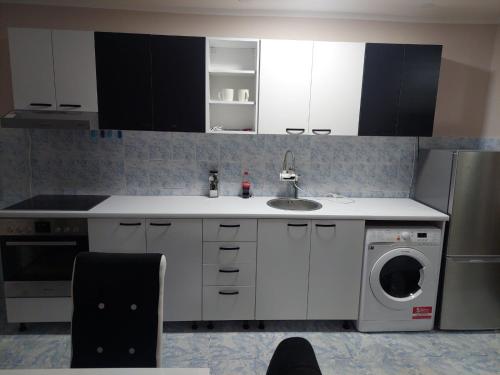 a kitchen with a sink and a washing machine at Rajna in Pirot