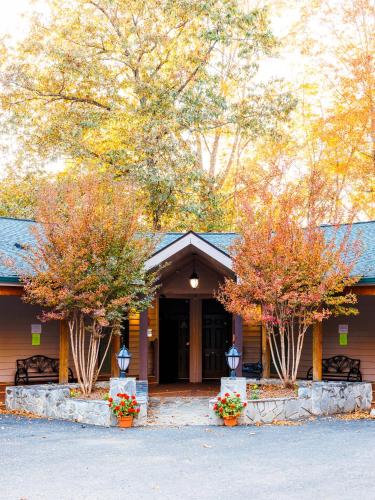 a building with two trees in front of it at Halesford Harbour Resort - Smith Mountain Lake in Moneta