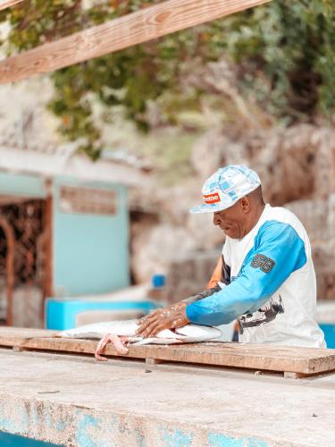 a man is working on a piece of wood at BijBlauw in Willemstad