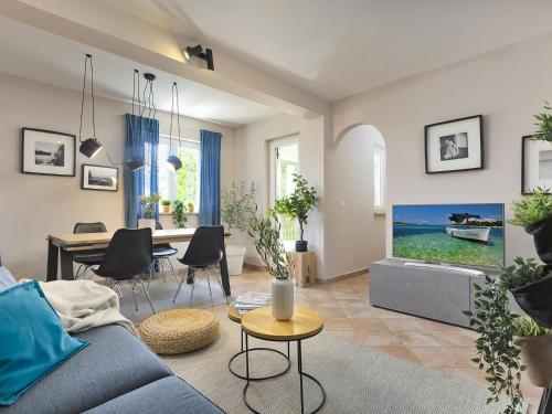 a living room with a blue couch and a table at Dream Istria Holiday in Poreč