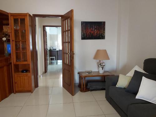 a living room with a couch and a table at Casa da Alegria - apartamento acolhedor no centro de Olhão in Olhão