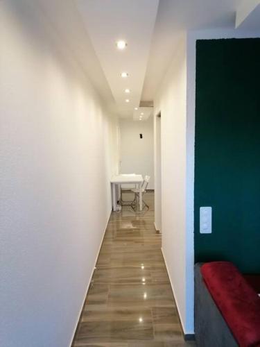 a hallway with a table and a red couch at Luxury Voll möblierte 2 Zimmer Appartement Aarau in Küttigen