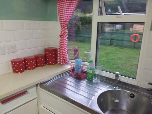 a kitchen counter with a sink and a window at Rockets's Retreat in Bursledon