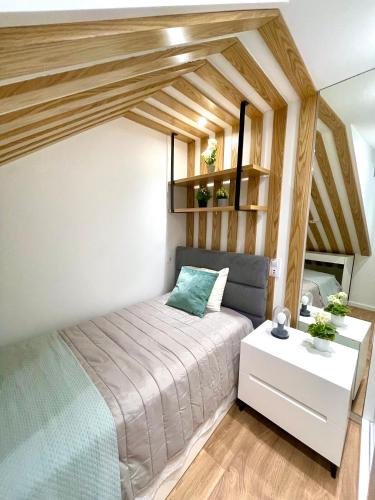a small bedroom with a bed and a table at Foz Douro in Porto