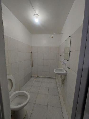 a bathroom with two toilets and a sink at Hotel Pousada dos Sonhos in São Luís