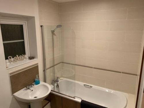 a bathroom with a sink and a shower and a bath tub at Modern Apartment in Barry Waterfront in Barry