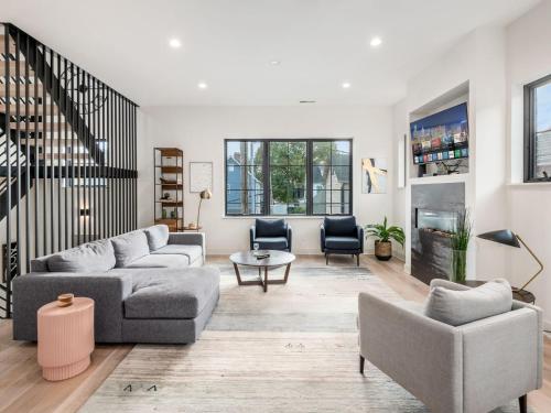 a living room with two couches and a table at Historic German Village Industrial Masterpiece in Columbus