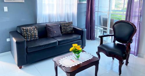 a living room with a couch and a chair at Cozy 2BR Near Playa Dorada, 3 Min In Car in San Felipe de Puerto Plata