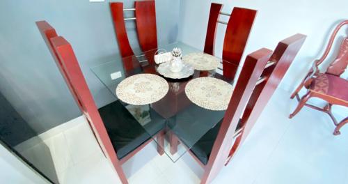 a dining room with two tables and chairs at Cozy 2BR Near Playa Dorada, 3 Min In Car in San Felipe de Puerto Plata
