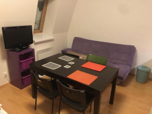 a living room with a table and a couch at Apartmán Ramzová Kometa in Ostružná