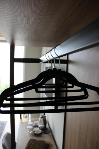 a coat hanging from a rack on a shelf at Kraal Hotel Vlore in Vlorë