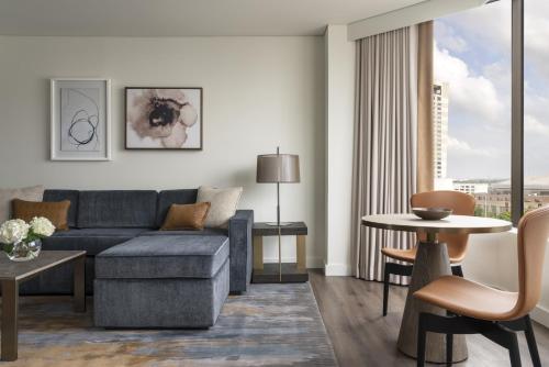 a living room with a couch and a table at Four Seasons Hotel Houston in Houston