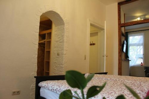 a bedroom with a bed in a room with a window at Wiesengrund in Bad Harzburg