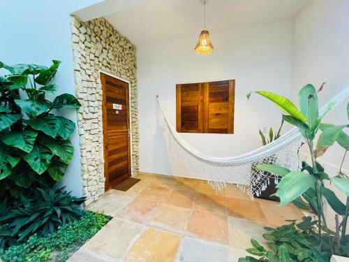 a hallway of a house with a door and plants at Villa Mar Residence in Jericoacoara