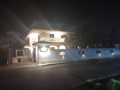 a white house with lights on it at night at B&B Domus Aurea 20 in San Giovanni Teatino