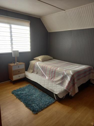 En eller flere senge i et værelse på Casa amplia y comoda en Puerto Montt