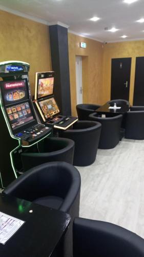 a room with black chairs and a video game arcade at Hotel Annis M&P in Dortmund