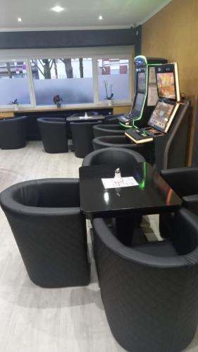 a waiting room with black chairs and a table at Hotel Annis M&P in Dortmund