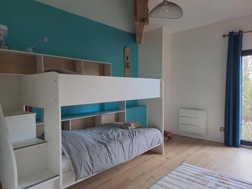 a white bunk bed in a room with blue walls at Domaine Ecoline in Sadirac