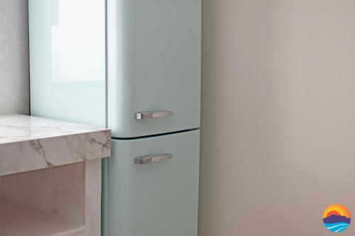 a refrigerator freezer sitting in a kitchen next to a counter at Casa Jaguar in Puerto Peñasco