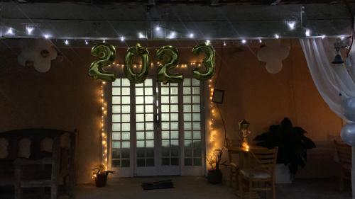 a room with a large window with christmas lights at Sítio Maranata Vale das Montanhas in Monte Alegre do Sul