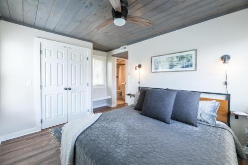a bedroom with a bed with blue pillows and a ceiling at Modern Mountain Escape in Gatlinburg