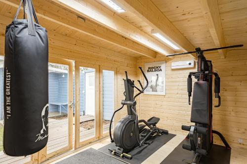 a gym with two exercise bikes and a punching bag at Liebevoll hinterm Deich - Ferienwohnungen in Lehe