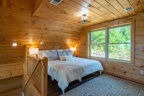 a bedroom with a bed in a wooden cabin at Mountain Mist in Gatlinburg
