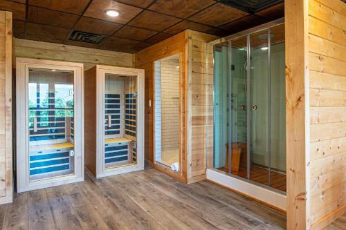 a room with three glass doors on a house at Mountain Mist in Gatlinburg