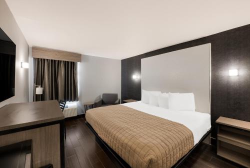 a hotel room with a bed and a desk at Essence Express Wayne in Wayne