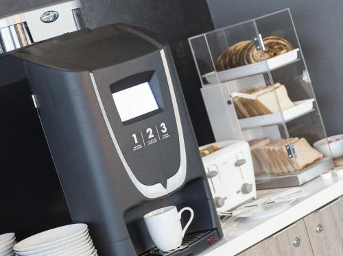 a coffee machine sitting on top of a counter at Liberty Suites in Thornhill