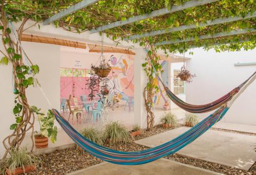 a hammock in the courtyard of a house with a mural at Casa Celeste Honda in Honda