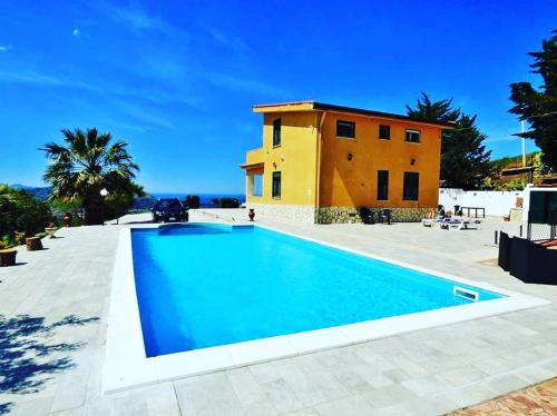 una grande piscina di fronte a una casa di Villa Bella Vista a Palermo