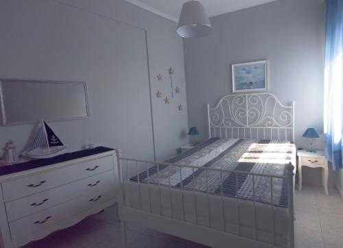 1 dormitorio blanco con 1 cama y vestidor en Lucky's studio en Ofrínion