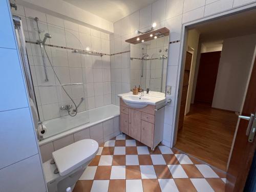 a bathroom with a sink and a toilet and a shower at Ferienwohnung am See, Überlingen in Überlingen